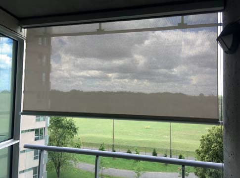 Cable guided exterior shade on a condo balcony